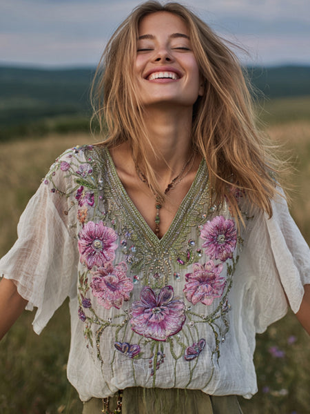 Blusa de mujer con cuello en V y bordado floral desgastado 